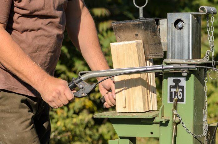 Man is using a electric log splitter