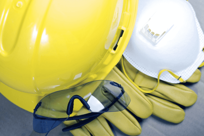 Safety Protective Work Equipment. Yellow Helmet, Glasses, Gloves and Mask. Protection Gear Closeup.