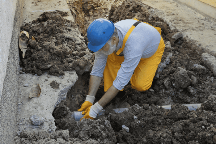 home renovation plumber fixing sewerage pipe