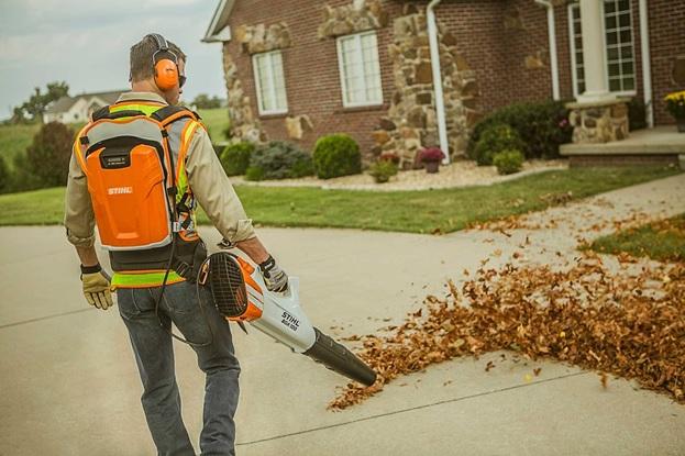 man using battery powered leaf blower