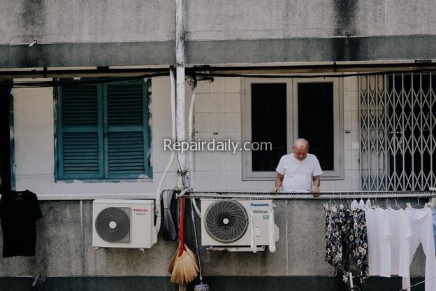 man looking at air conditioner