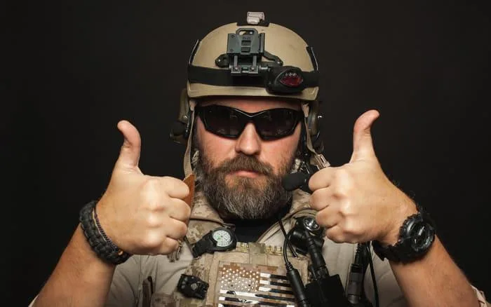 Brutal-man-in-military-uniform-shows-two-fingers