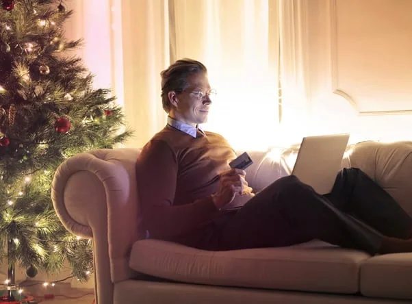 man sitting on couch with laptop man sitting on couch with laptop