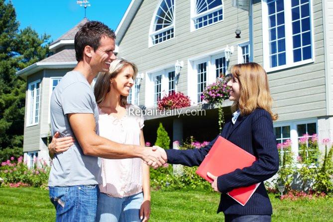 couples handshaking with real estate agent