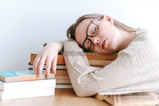 lady sleeping on books