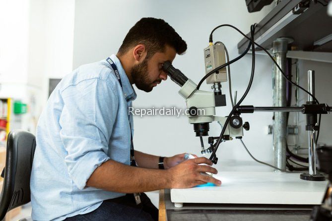 engineer working on microscope
