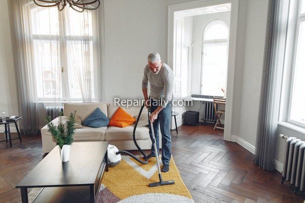 cleaning carpet with vacuum cleaner