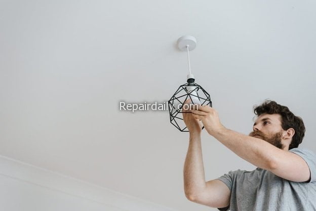 electrician changing bulb