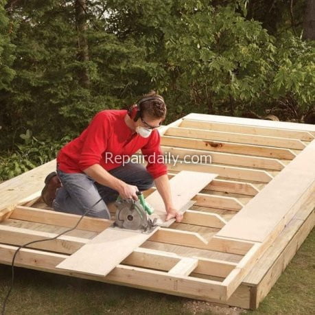 man building a shed