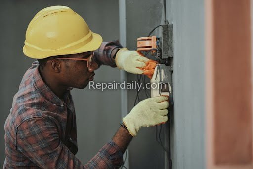 man fixing electricla problem