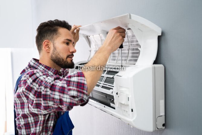 man repairing ac