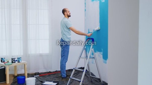 man painting wall