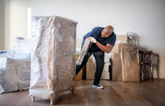man packing furniture to move