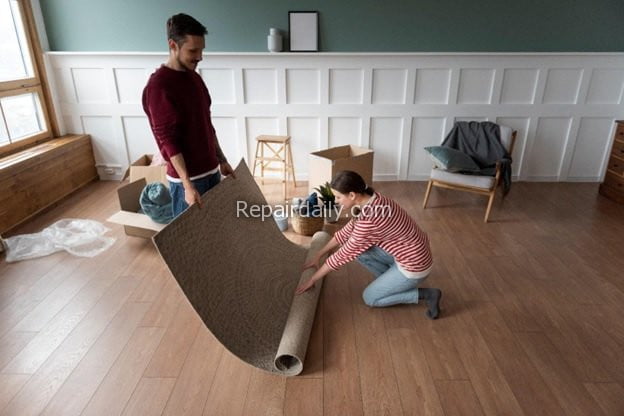 couple laying mat flooring