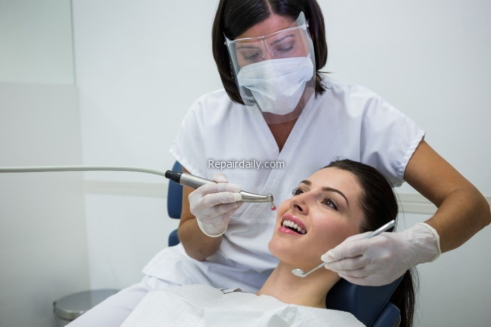 dentist-examining-female-patient-with-tools