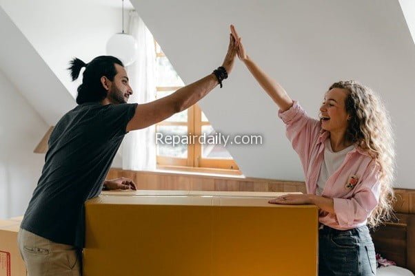couple high five after moving to new home