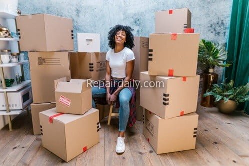 girl poses with moving boxes