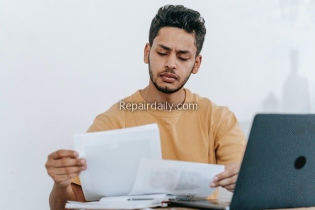 guy looking at documents paperwork