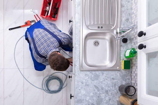 cleaning sink drain by professional plumbing