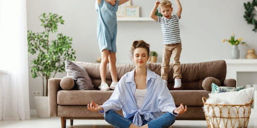 lady meditating children playing in background using AC