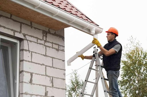 man installing gutter