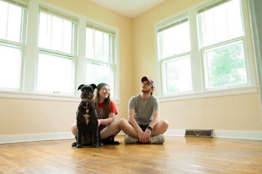 couple and dog in empty room